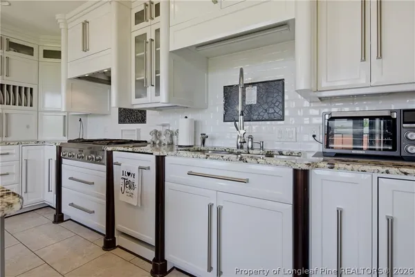 a kitchen with cabinets appliances a sink and a counter top space