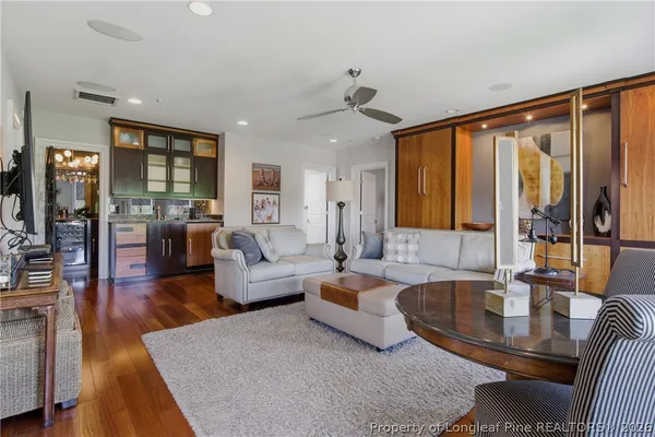 a living room with furniture and wooden floor