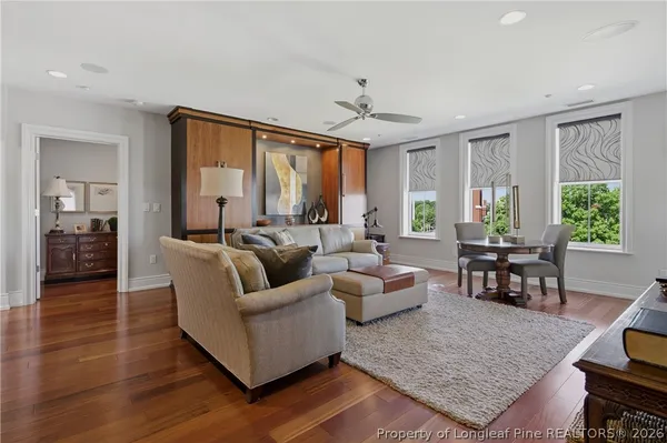 a living room with furniture and wooden floor