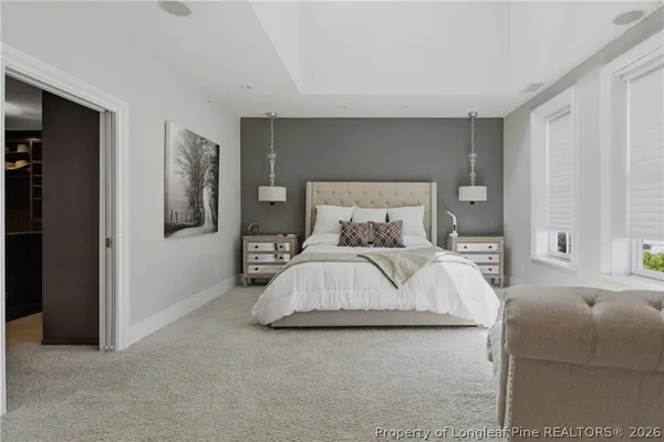 a bedroom with a bed and painting on the wall