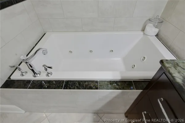 a bathroom with a bathtub and shower