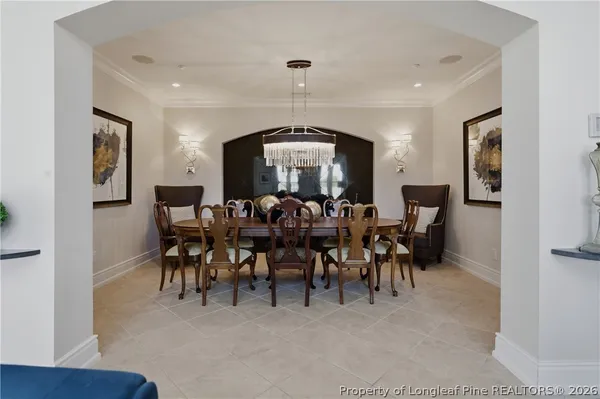 a view of a big room with lots of tables a chandelier