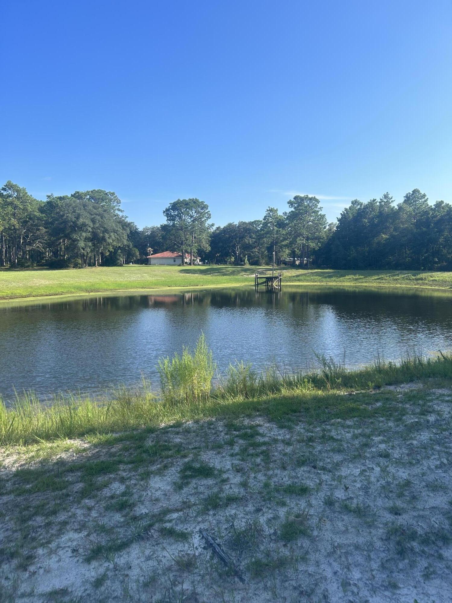 329 Sunflower Lane Freeport, FL 32439 - Photo 32 of 39 a view of a lake with houses in the back