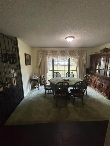 a view of a dining room with furniture and window