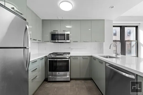 a kitchen with stainless steel appliances a sink stove and refrigerator
