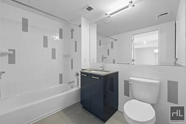 a bathroom with a toilet a sink a mirror a bathtub and shower