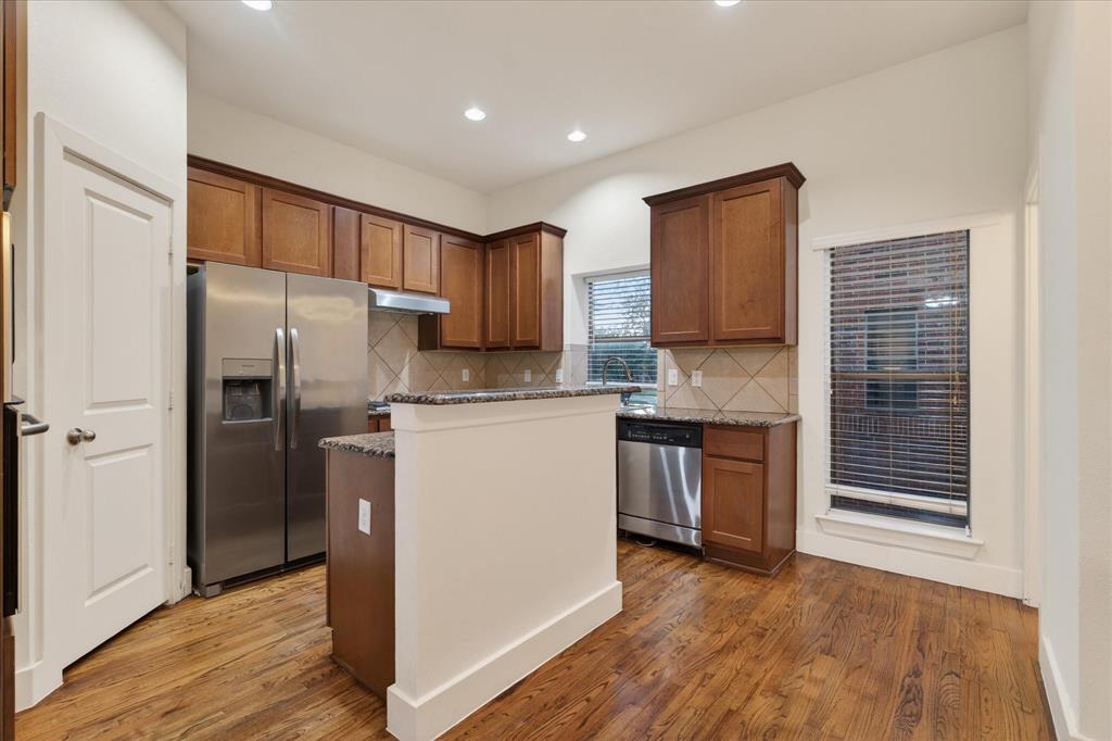 4105 Lafayette Street Dallas, TX 75204 - Photo 11 of 26 a kitchen with refrigerator cabinets and wooden floor