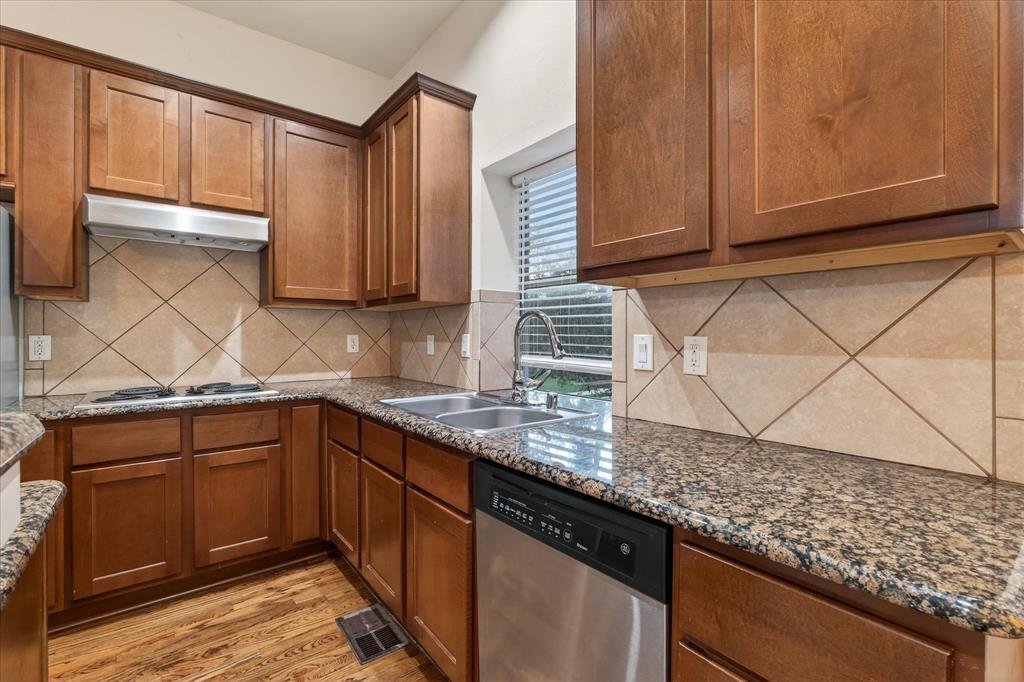 4105 Lafayette Street Dallas, TX 75204 - Photo 12 of 26 a kitchen with granite countertop cabinets sink and stove