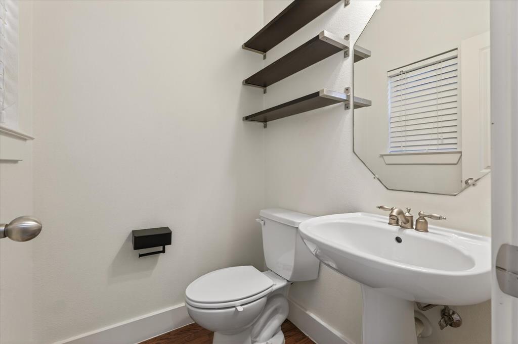 4105 Lafayette Street Dallas, TX 75204 - Photo 13 of 26 a bathroom with a sink toilet and a mirror