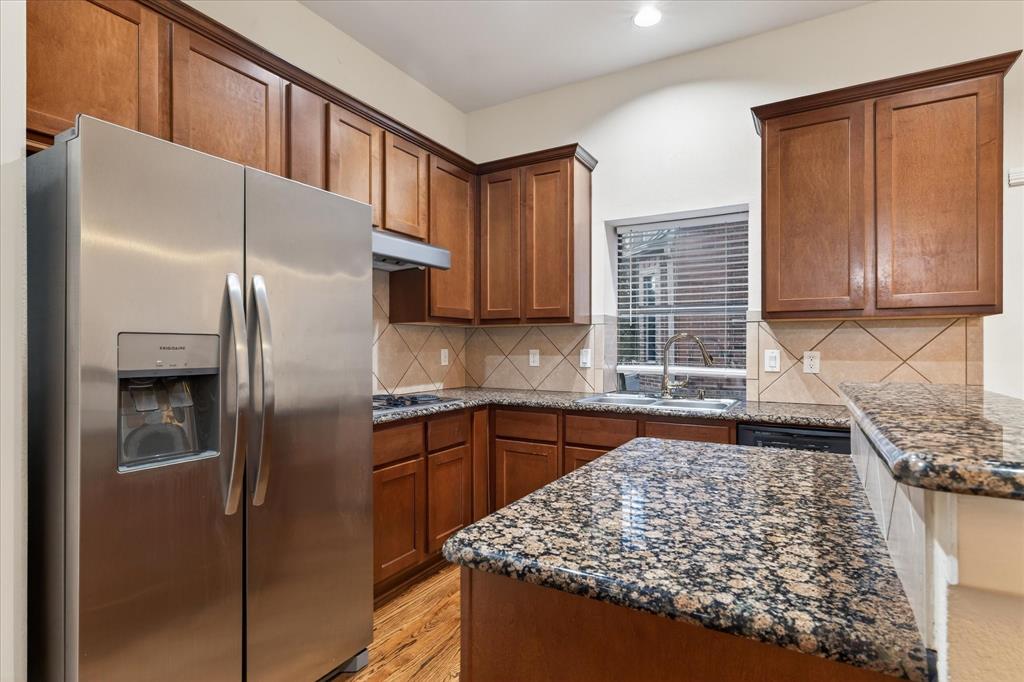 4105 Lafayette Street Dallas, TX 75204 - Photo 16 of 26 a kitchen with stainless steel appliances granite countertop a refrigerator and a sink