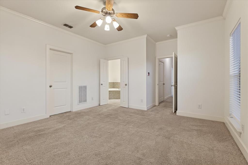 4105 Lafayette Street Dallas, TX 75204 - Photo 21 of 26 an empty room with closet and a chandelier fan