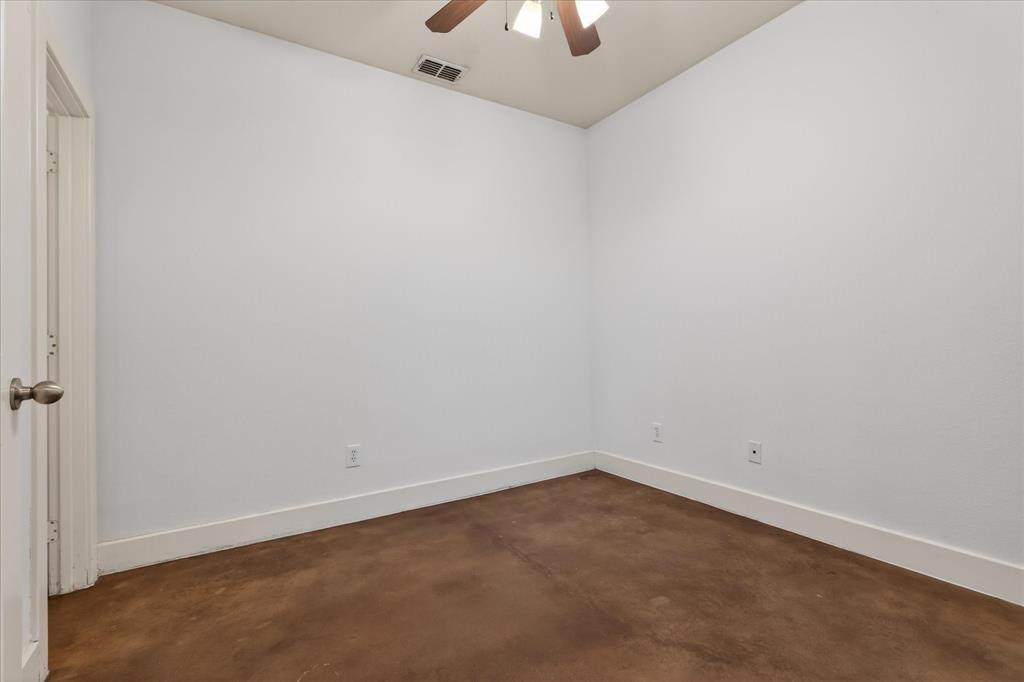 4105 Lafayette Street Dallas, TX 75204 - Photo 4 of 26 an empty room with a chandelier fan and closet