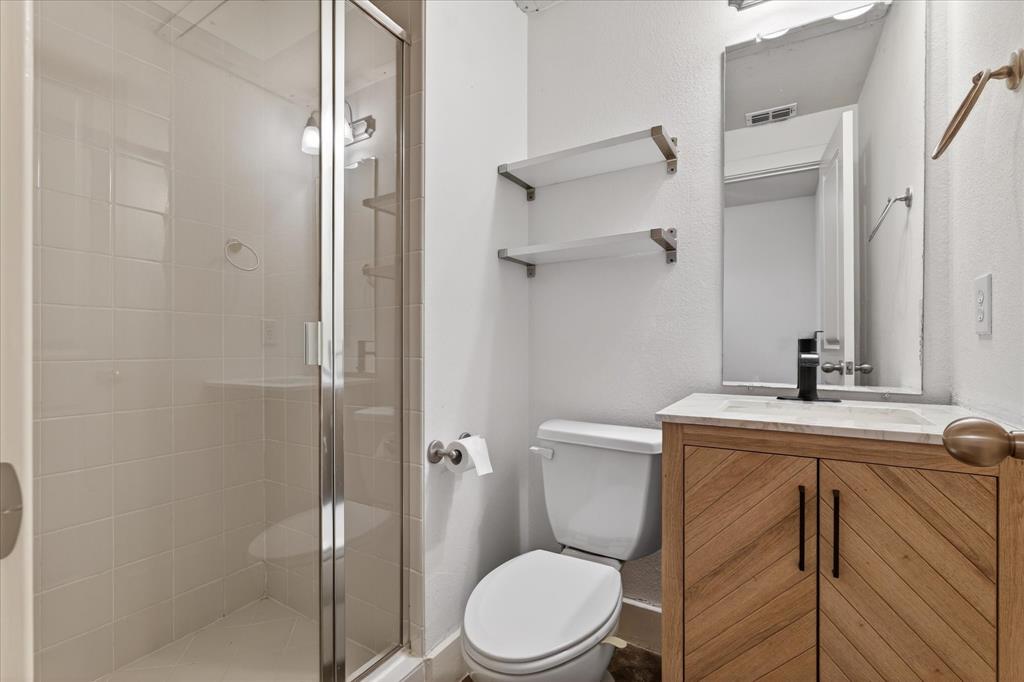 4105 Lafayette Street Dallas, TX 75204 - Photo 6 of 26 a bathroom with a granite countertop toilet sink and shower