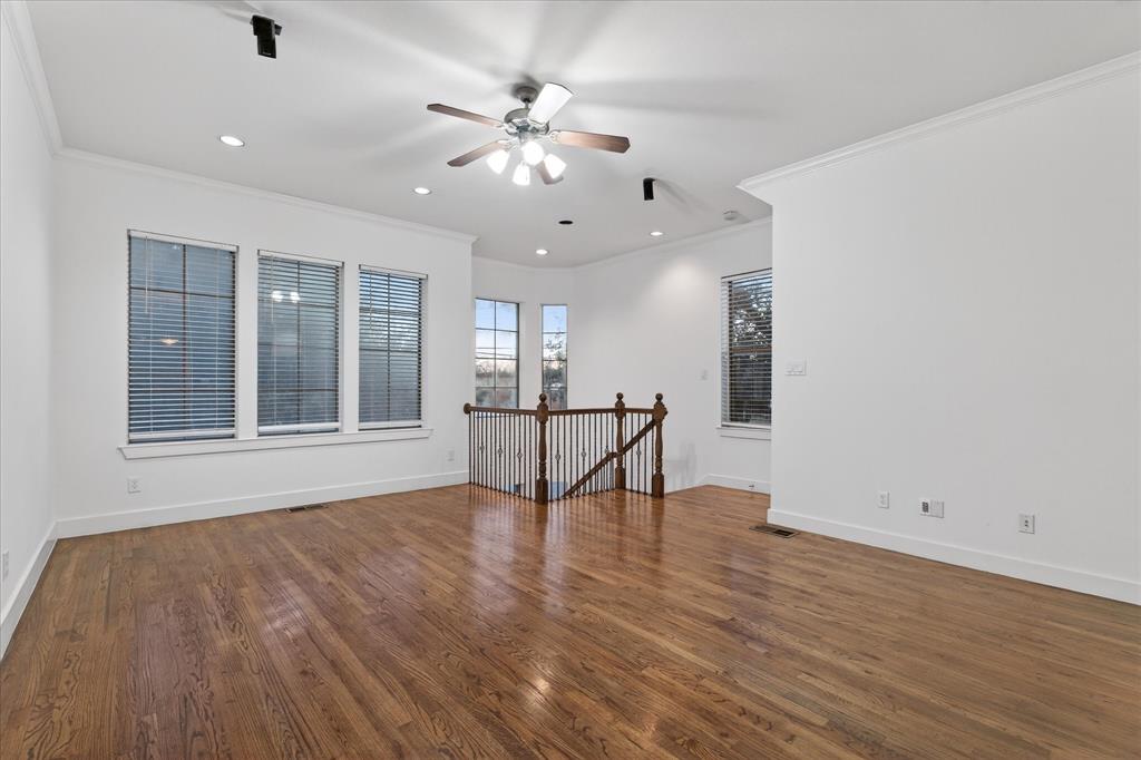 4105 Lafayette Street Dallas, TX 75204 - Photo 9 of 26 a view of an empty room with a window and wooden floor