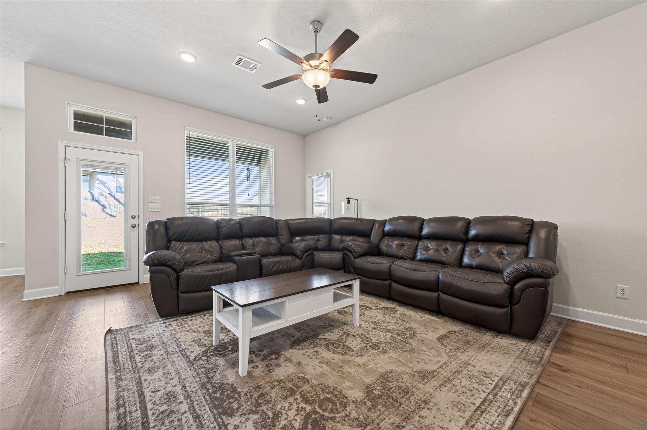 917 Farm Path Brenham, TX 77833 - Photo 7 of 43 a living room with furniture a large window and a chandelier