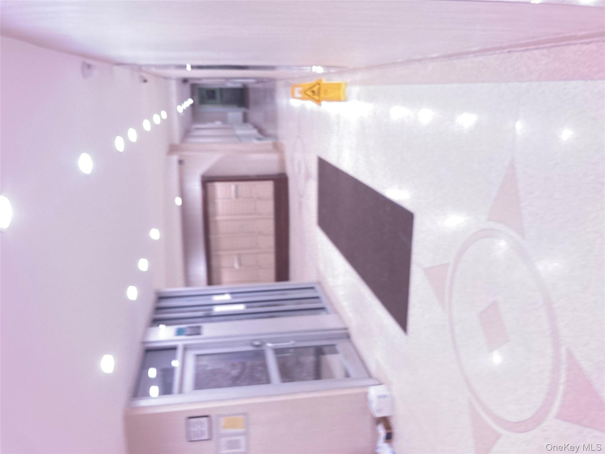 62-59 108th Street, Unit 6E Queens, NY 11375 - Photo 13 of 14 a view of a hallway with two chairs and a refrigerator