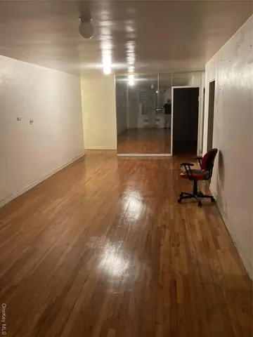 a view of room with wooden floor and furniture