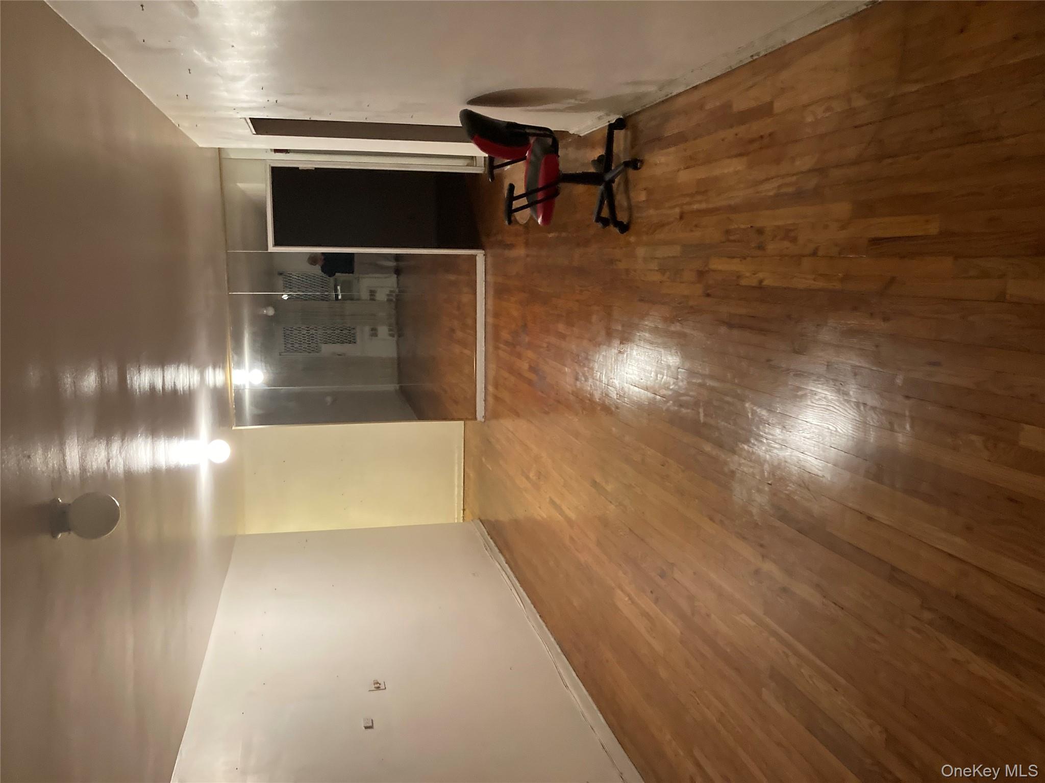 62-59 108th Street, Unit 6E Queens, NY 11375 - Photo 3 of 14 a view of room with wooden floor and furniture