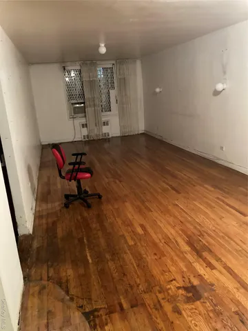 a view of a room with wooden floor and staircase