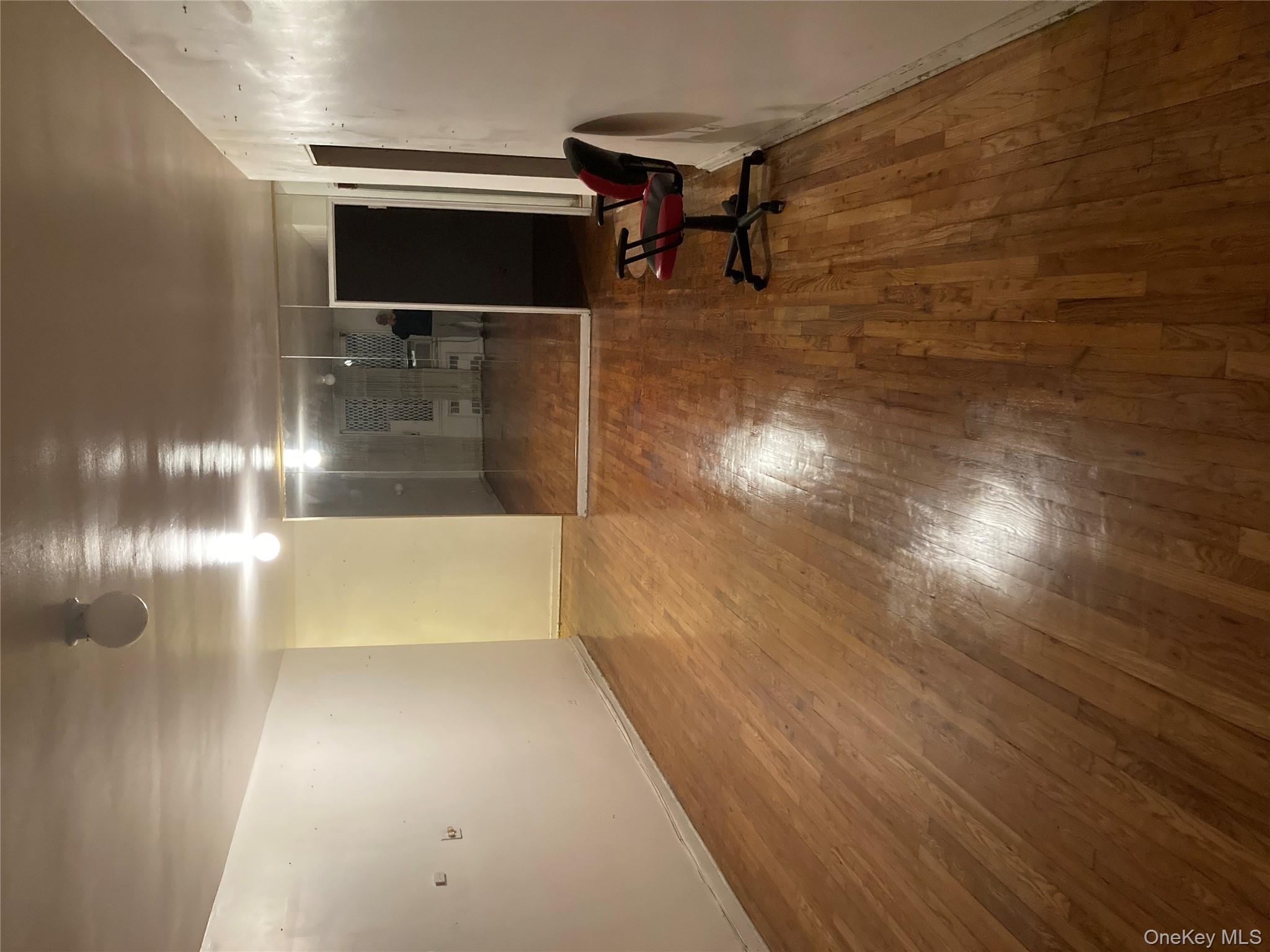 62-59 108th Street, Unit 6E Queens, NY 11375 - Photo 5 of 14 a view of a room with wooden floor and staircase