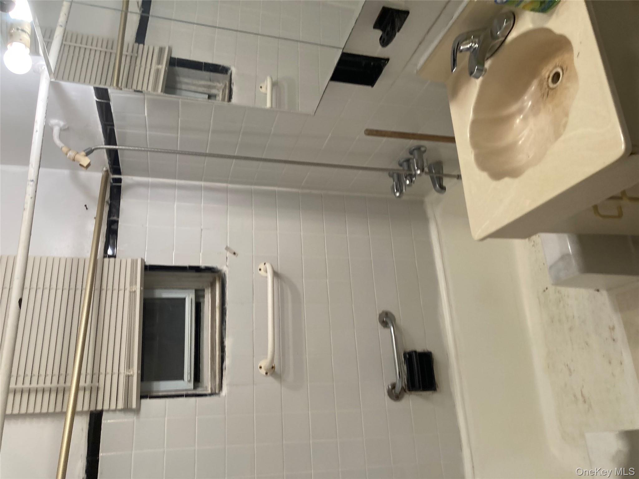 62-59 108th Street, Unit 6E Queens, NY 11375 - Photo 9 of 14 a bathroom with a sink and a mirror