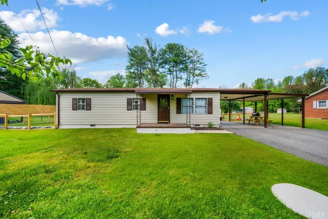 a front view of a house with yard patio and green space