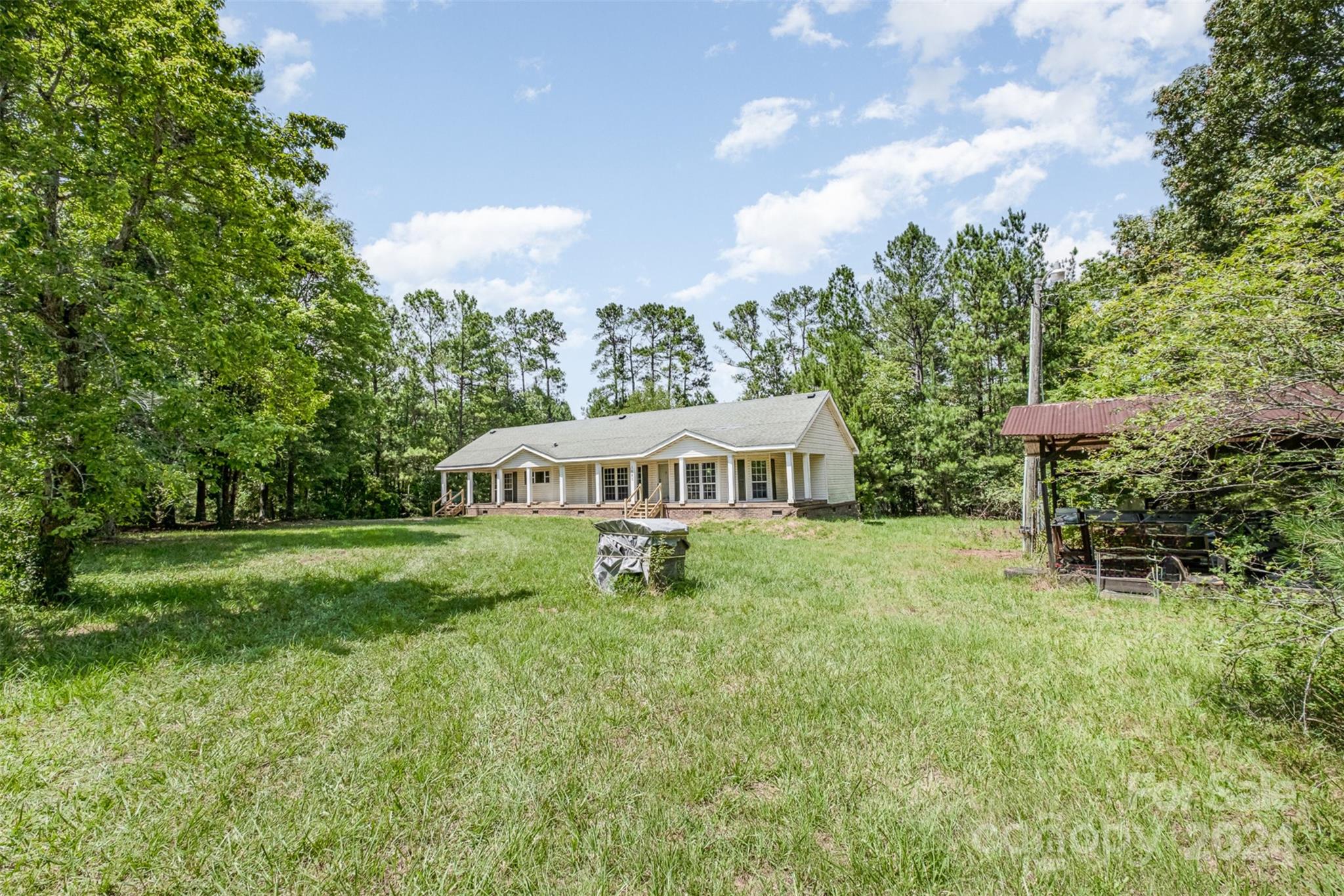 1680 Thompson Quarters Road Sharon, SC 29742 - Photo 8 of 37 a front view of a house with garden