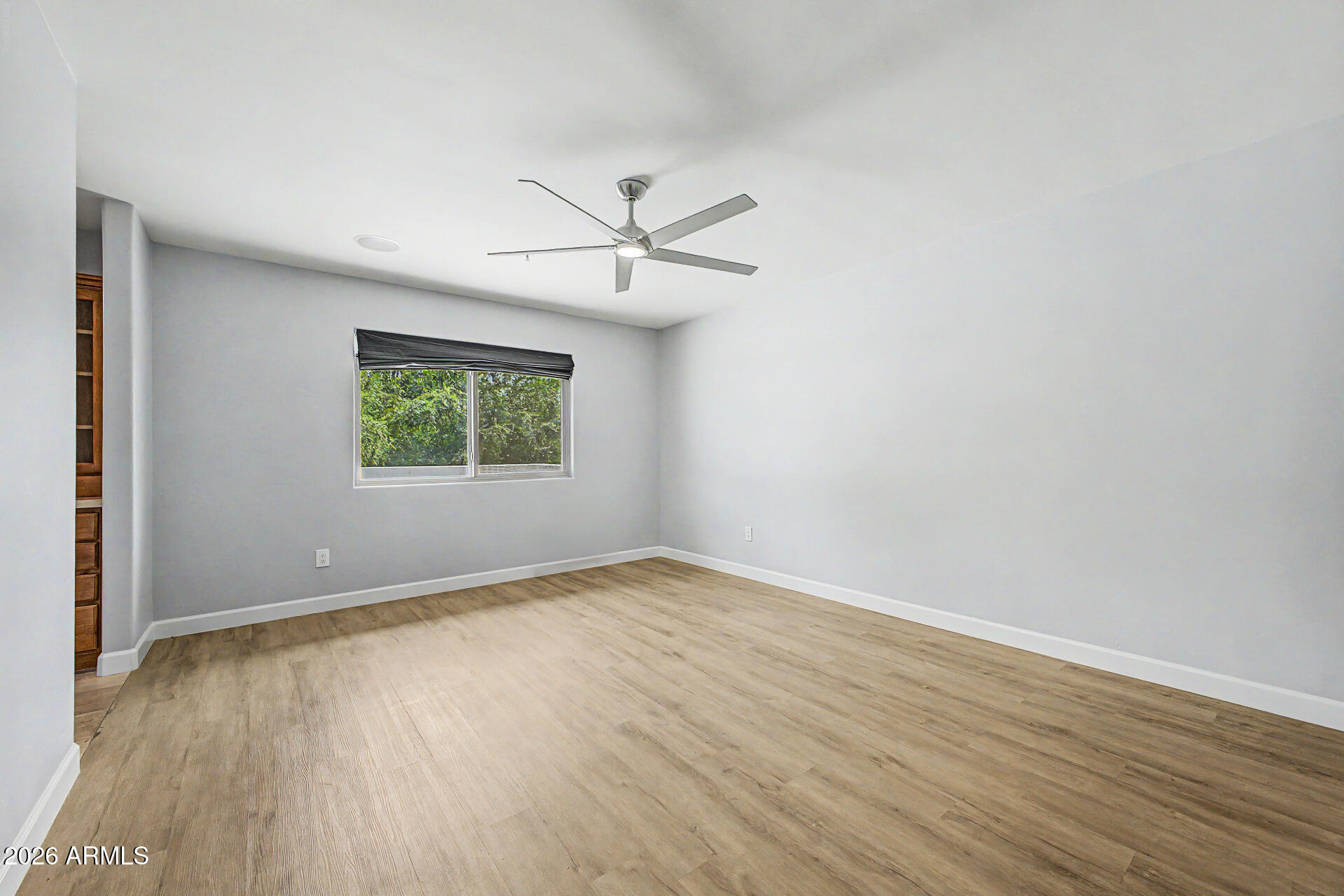 2311 East Colter Street Phoenix, AZ 85016 - Photo 29 of 93 an empty room with wooden floor and windows