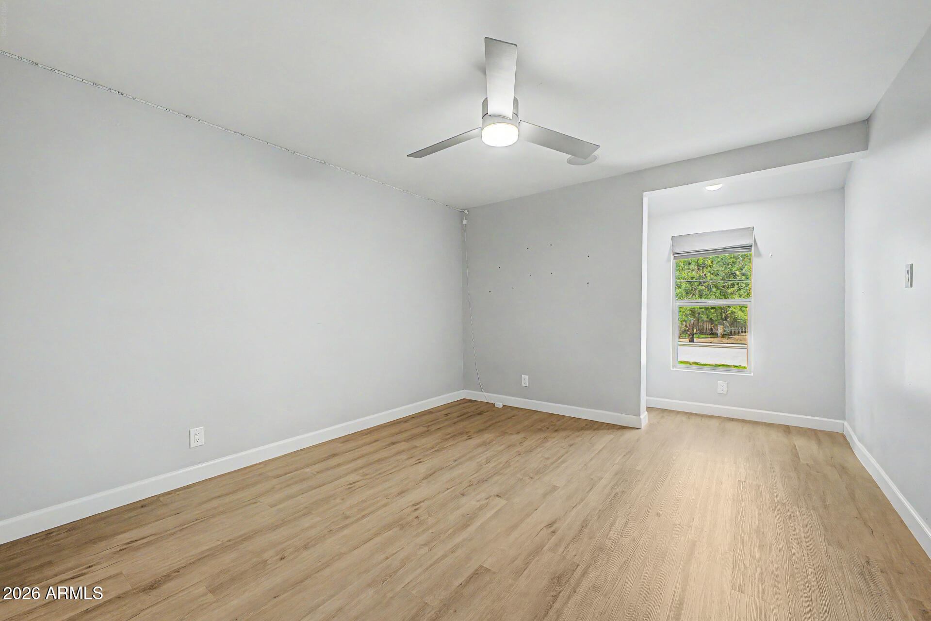 2311 East Colter Street Phoenix, AZ 85016 - Photo 34 of 93 an empty room with wooden floor chandelier and windows