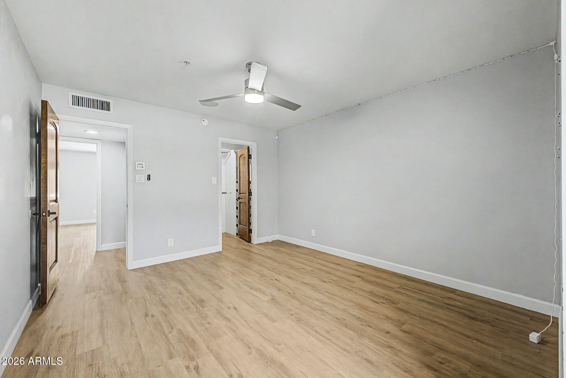 2311 East Colter Street Phoenix, AZ 85016 - Photo 35 of 93 a view of an empty room with wooden floor