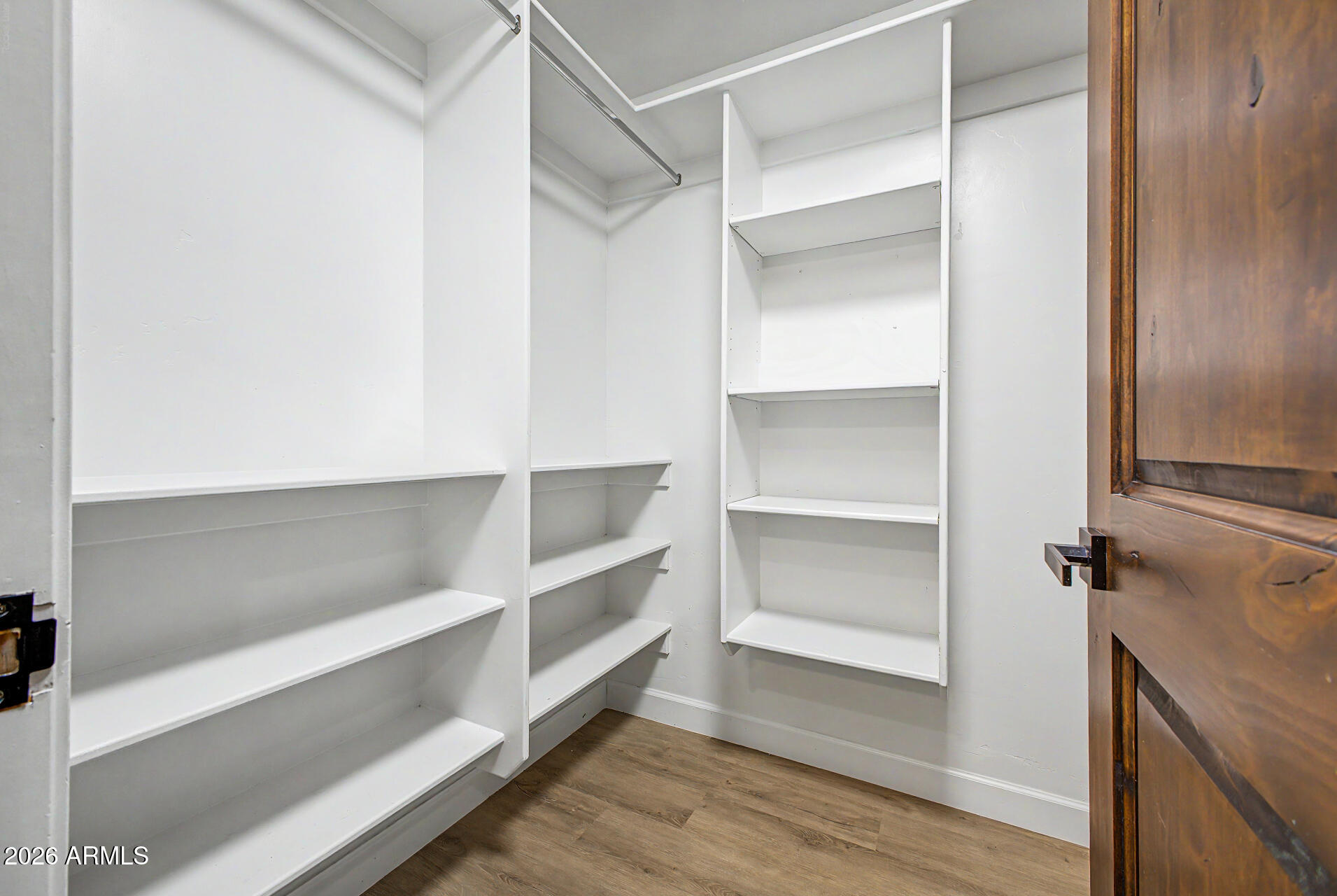 2311 East Colter Street Phoenix, AZ 85016 - Photo 36 of 93 a view of walk in closet with empty racks