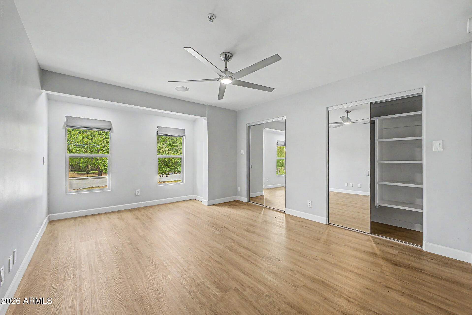 2311 East Colter Street Phoenix, AZ 85016 - Photo 38 of 93 a view of an empty room with a window and wooden floor