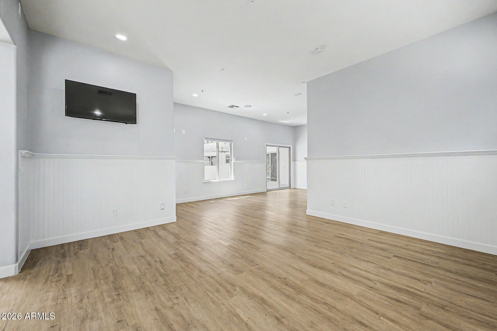 2311 East Colter Street Phoenix, AZ 85016 - Photo 41 of 93 a view of an empty room with wooden floor and a window