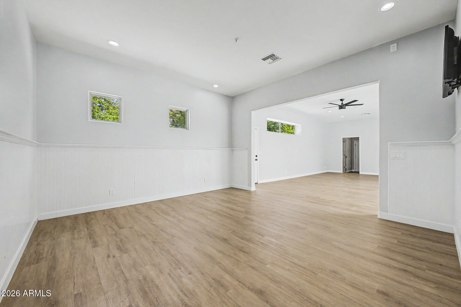 2311 East Colter Street Phoenix, AZ 85016 - Photo 44 of 93 an empty room with wooden floor and windows