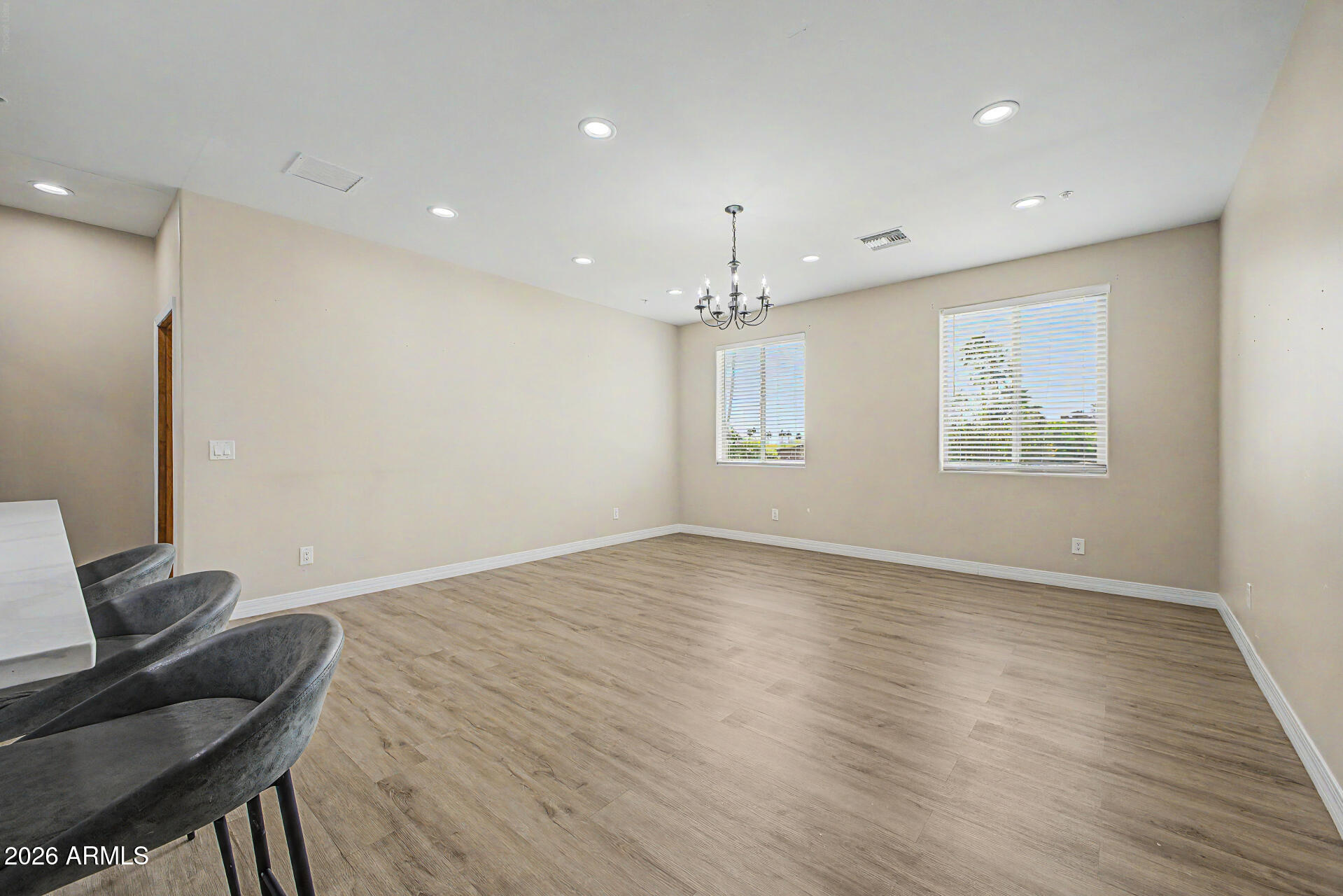 2311 East Colter Street Phoenix, AZ 85016 - Photo 50 of 93 a view of an empty room with a window and wooden floor