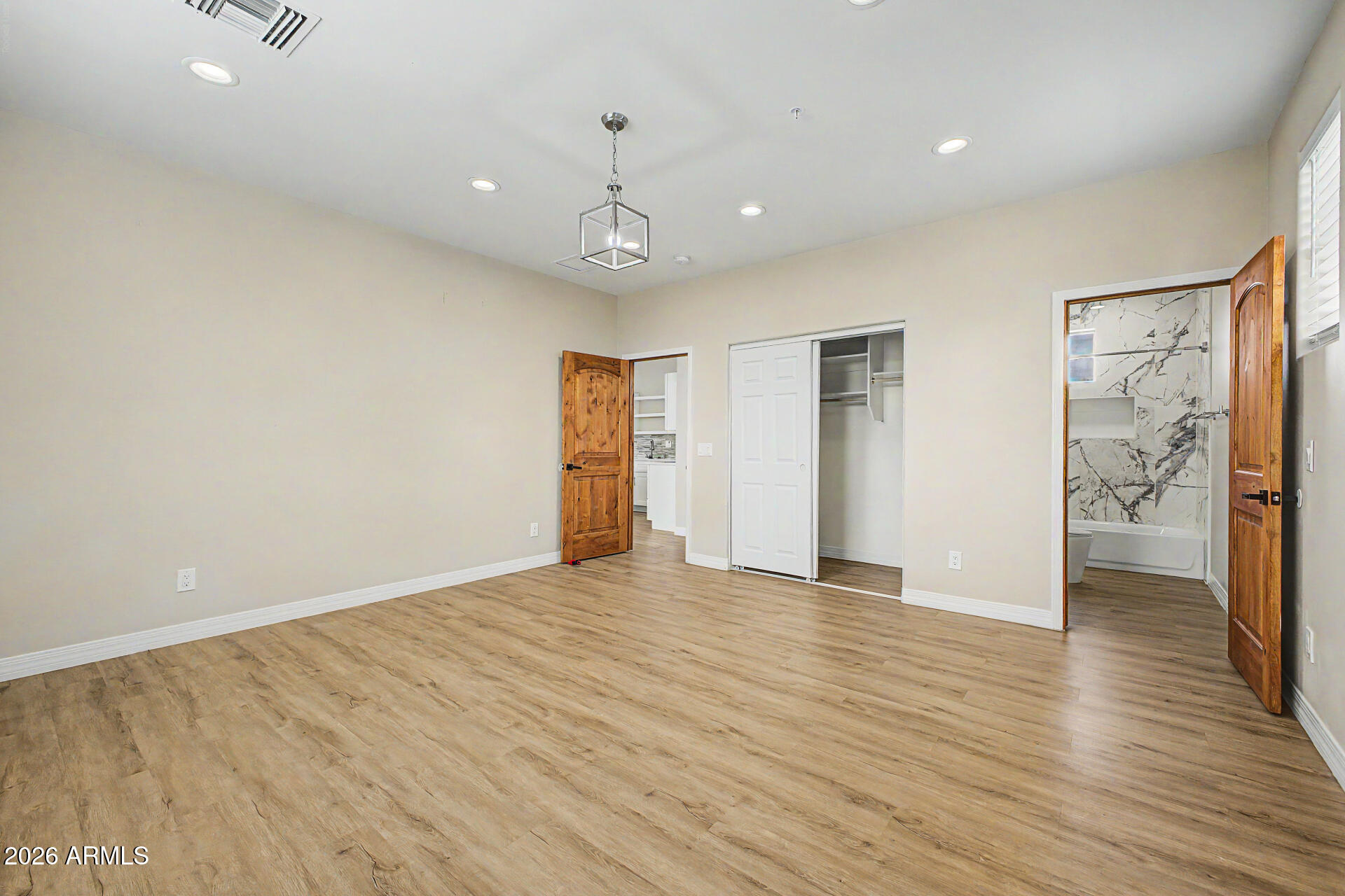 2311 East Colter Street Phoenix, AZ 85016 - Photo 56 of 93 an empty room with wooden floor and windows