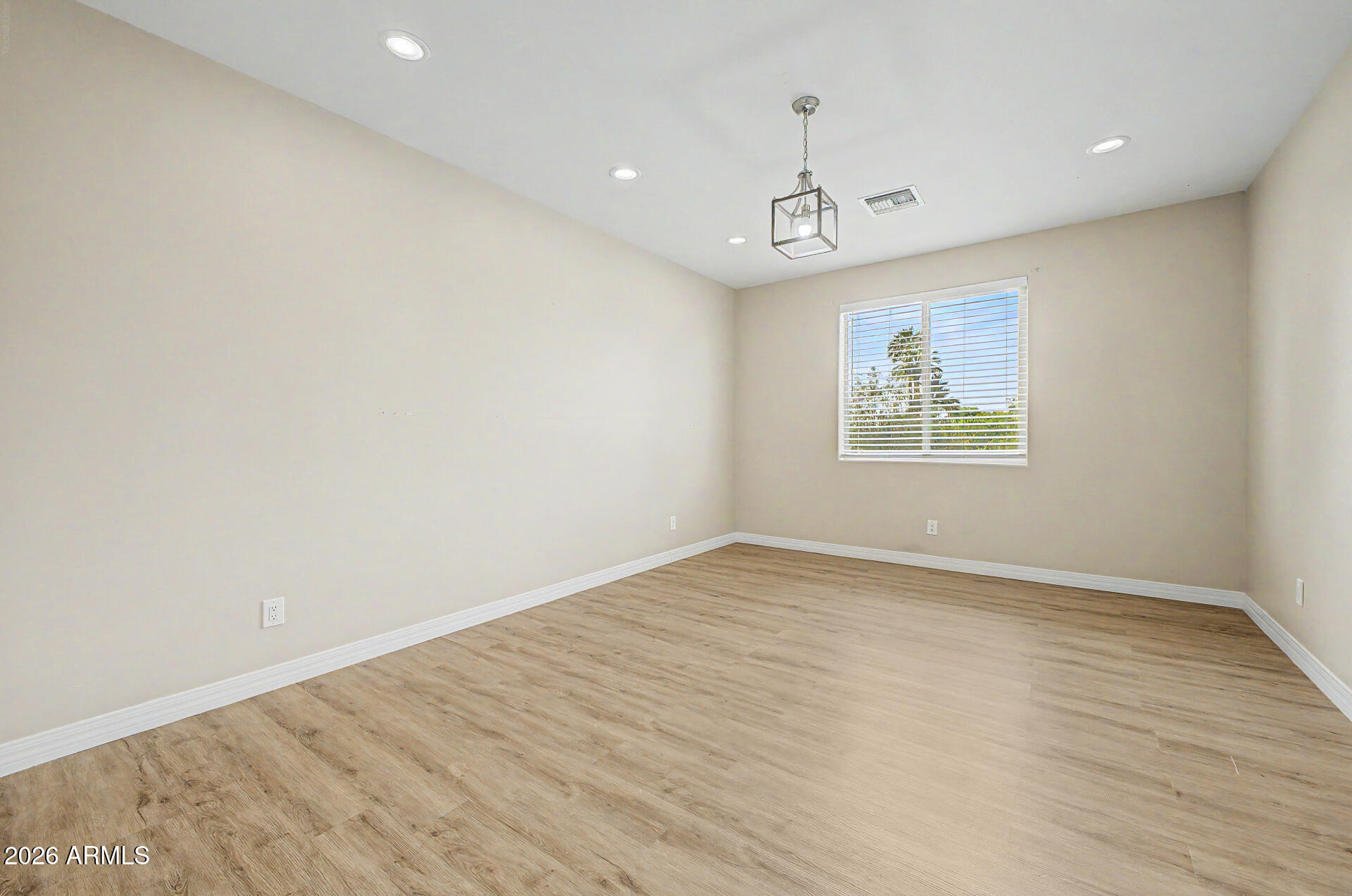 2311 East Colter Street Phoenix, AZ 85016 - Photo 59 of 93 an empty room with wooden floor chandelier and windows