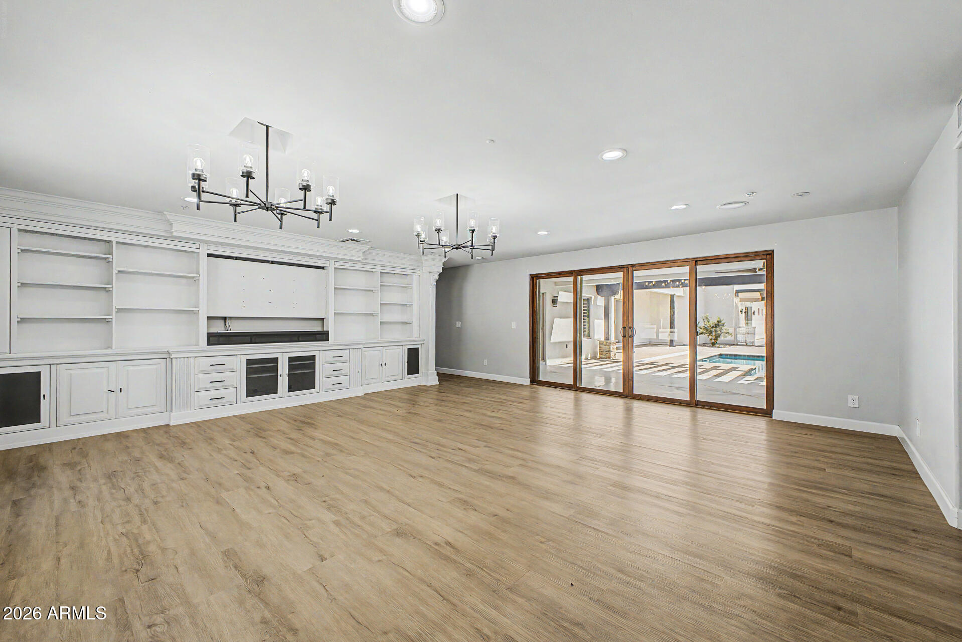 2311 East Colter Street Phoenix, AZ 85016 - Photo 7 of 93 a view of an empty room with a window and wooden floor