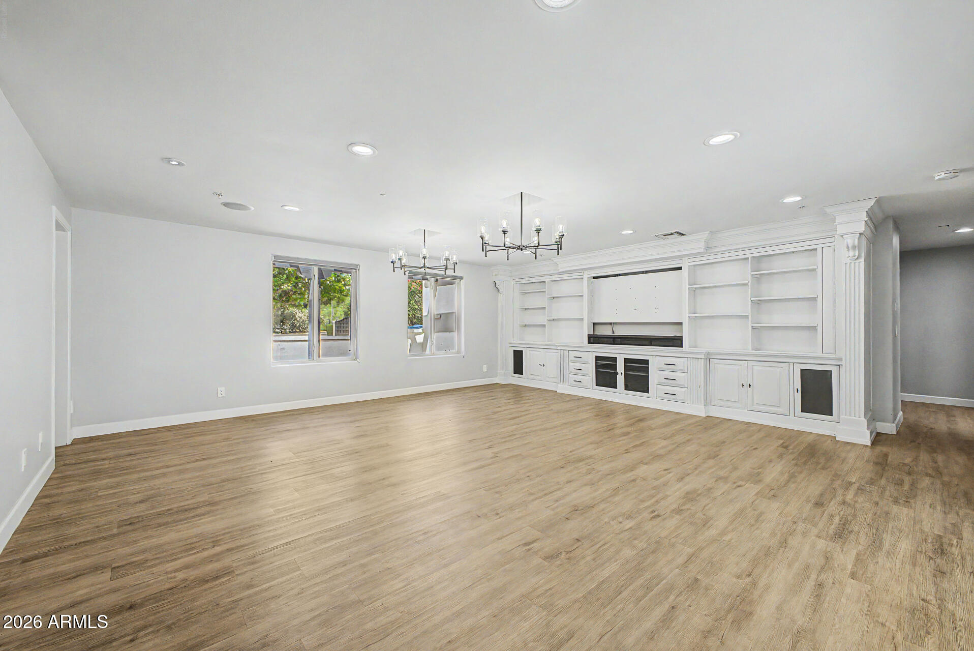 2311 East Colter Street Phoenix, AZ 85016 - Photo 8 of 93 an empty room with wooden floor and windows