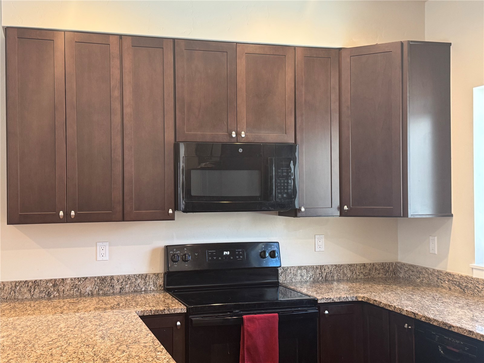 55 Ermine Road Dillon, CO 80435 - Photo 5 of 16 Kitchen with light stone counters, black appliances, and dark brown cabinets