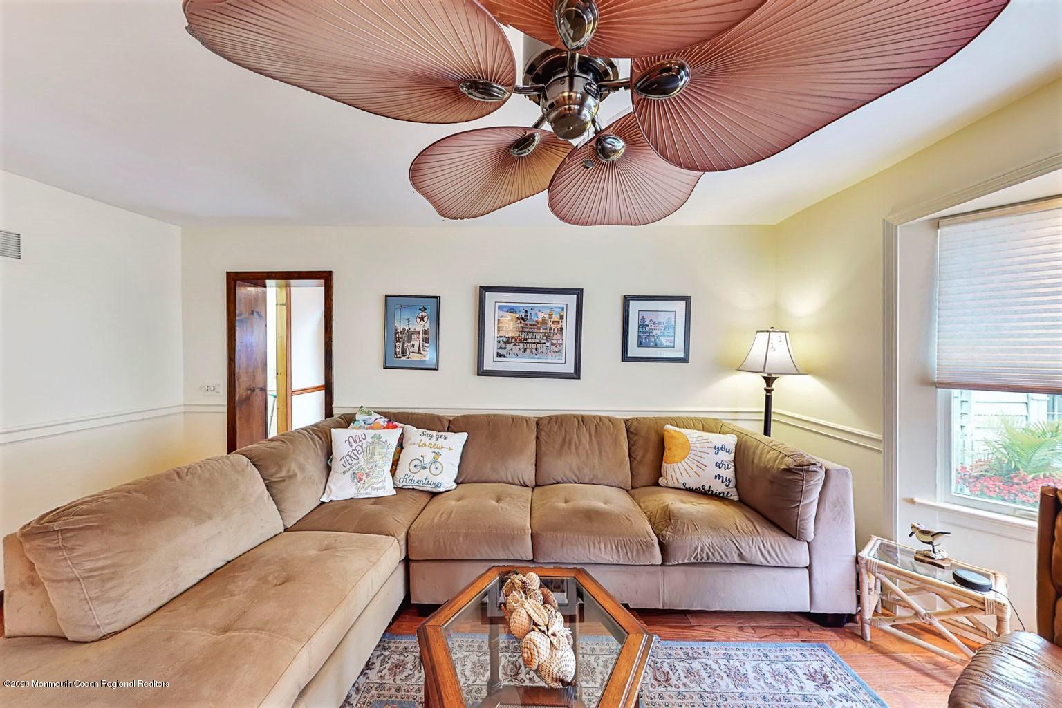 54 Ridge Avenue Manasquan, NJ 08736 - Photo 12 of 42 a living room with furniture a ceiling fan and a window