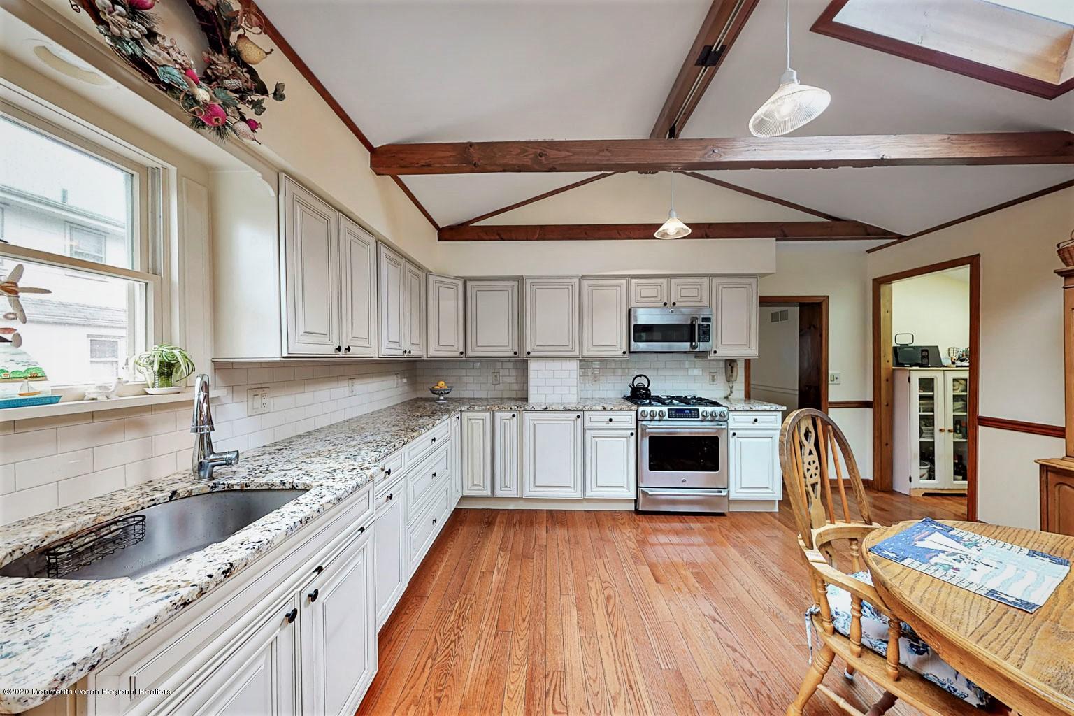 54 Ridge Avenue Manasquan, NJ 08736 - Photo 17 of 42 a kitchen with a sink and a stove top oven