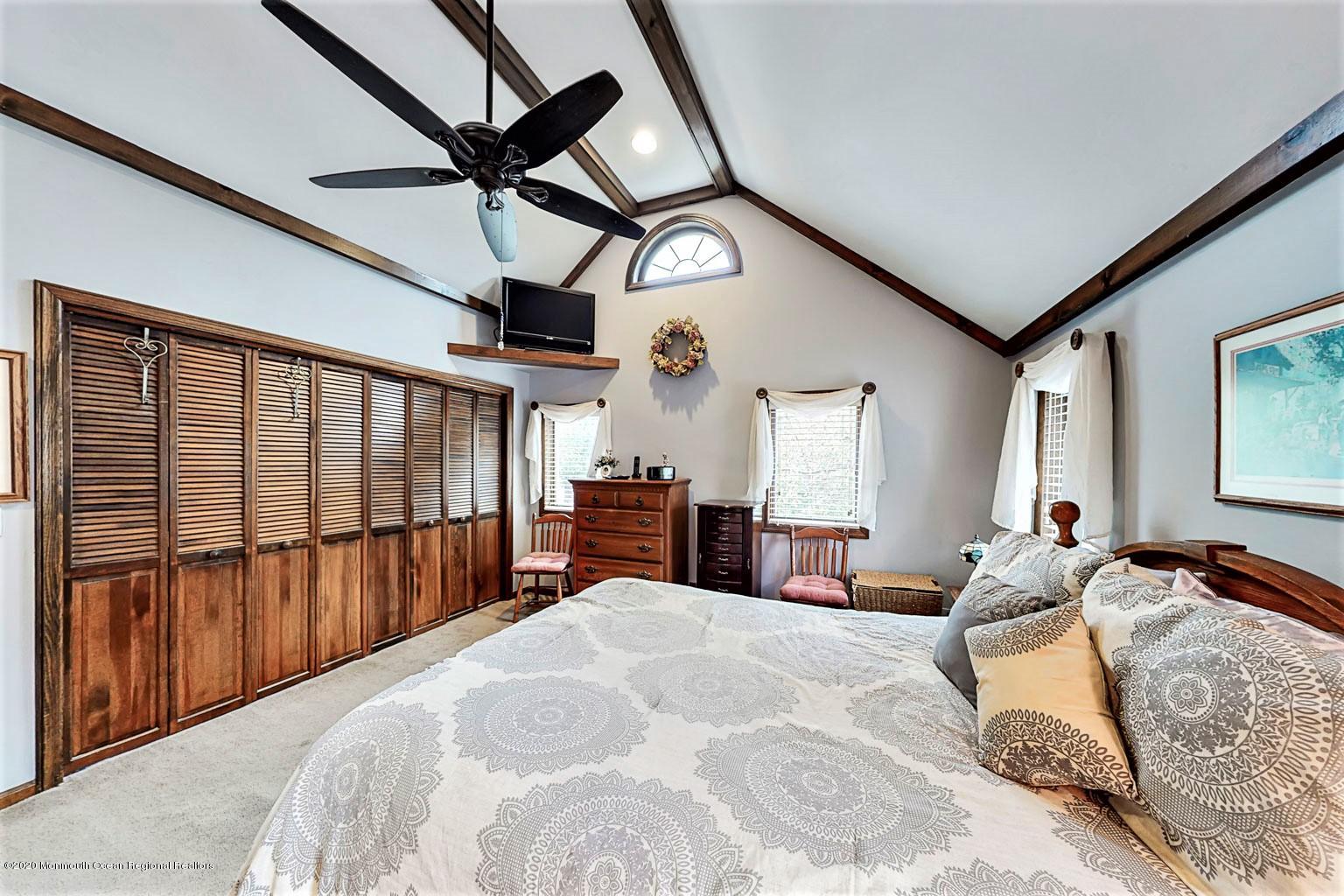 54 Ridge Avenue Manasquan, NJ 08736 - Photo 21 of 42 a bed room with a bed and a large window