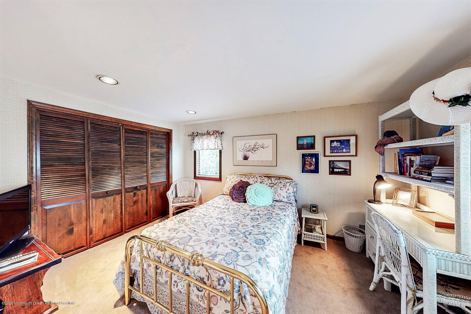 54 Ridge Avenue Manasquan, NJ 08736 - Photo 25 of 42 a bedroom with a bed a dresser and next to a window