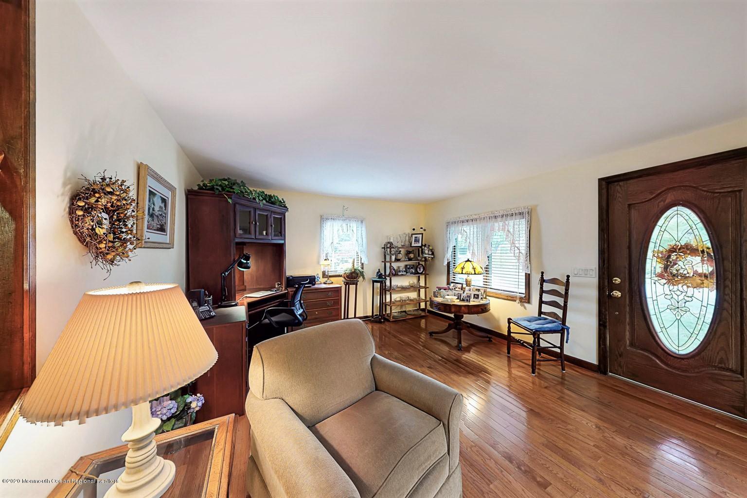 54 Ridge Avenue Manasquan, NJ 08736 - Photo 7 of 42 a living room with furniture a rug a fireplace and a large window