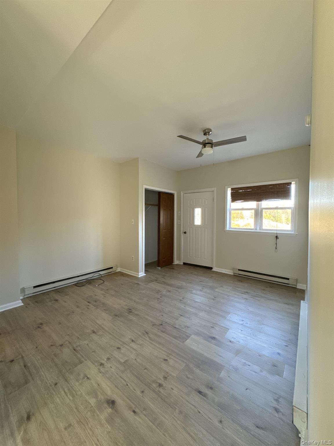 400 Round Lake Road, Unit A Rhinebeck, NY 12572 - Photo 8 of 11 an empty room with a window and a ceiling fan