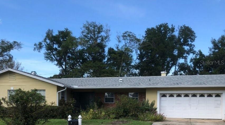 a view of a white house with a outdoor space and garden view
