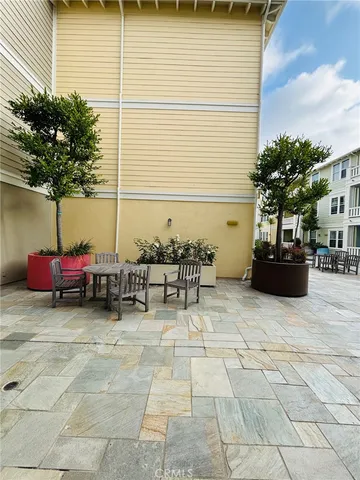 a view of a patio with table and chairs and potted plants