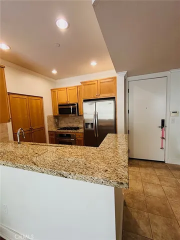 a view of kitchen island a sink wooden floor and a counter top space