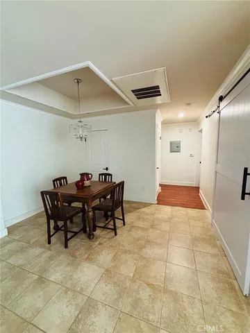 a view of a dining room with furniture and a chandelier